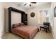 Bedroom with murphy bed, chair, and large window with shutters at 12350 W Bajada Rd, Peoria, AZ 85383