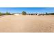 Aerial view of a property with a house, garage, and open land at 1430 W Maddock Rd, Phoenix, AZ 85086