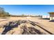 Spacious gravel backyard and a partial view of a neighboring house at 1430 W Maddock Rd, Phoenix, AZ 85086