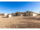 Back view of a house with a gravel yard, and a small outbuilding at 1430 W Maddock Rd, Phoenix, AZ 85086