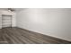 Empty bedroom with built-in shelving, wood-look floors, and white walls at 1430 W Maddock Rd, Phoenix, AZ 85086