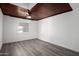 Spacious bedroom with wood-look flooring, white walls, and wood-paneled ceiling at 1430 W Maddock Rd, Phoenix, AZ 85086