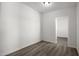 Empty room with wood-look flooring, white walls, and doorway to another room at 1430 W Maddock Rd, Phoenix, AZ 85086