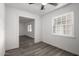 Bright bedroom with wood-look flooring and a ceiling fan at 1430 W Maddock Rd, Phoenix, AZ 85086
