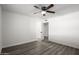 Bedroom with ceiling fan, wood-look flooring, and open door at 1430 W Maddock Rd, Phoenix, AZ 85086