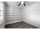 Bedroom with built-in shelving and wood-look flooring at 1430 W Maddock Rd, Phoenix, AZ 85086