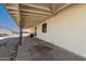 Covered back patio with wood beam ceiling and concrete slab at 1430 W Maddock Rd, Phoenix, AZ 85086