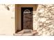 Close-up of a brown front door with a decorative window at 1430 W Maddock Rd, Phoenix, AZ 85086