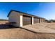 Exterior view of a four-car garage with brown doors and a concrete driveway at 1430 W Maddock Rd, Phoenix, AZ 85086