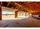 Garage interior with open door, wooden beams, and storage shelves at 1430 W Maddock Rd, Phoenix, AZ 85086
