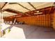 Large garage interior with high wooden ceilings, concrete floor, and storage at 1430 W Maddock Rd, Phoenix, AZ 85086