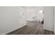 Hallway with gray wood-look flooring, white walls, and a white door at 1430 W Maddock Rd, Phoenix, AZ 85086