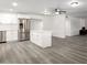 Modern white kitchen with island, stainless steel appliances, and updated fixtures at 1430 W Maddock Rd, Phoenix, AZ 85086
