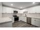 White kitchen with stainless steel appliances and white subway tile backsplash at 1430 W Maddock Rd, Phoenix, AZ 85086