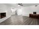 Living area with a fireplace, wood-look flooring, and view of the kitchen at 1430 W Maddock Rd, Phoenix, AZ 85086