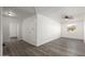 Living room with gray wood-look flooring, white walls, and ceiling fan at 1430 W Maddock Rd, Phoenix, AZ 85086