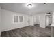 Bright open living room with wood-look flooring, white walls and French doors at 1430 W Maddock Rd, Phoenix, AZ 85086