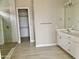 Large primary bathroom with walk-in shower, vanity, and view into closet at 18169 W Cactus Flower W Dr, Goodyear, AZ 85338