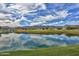 Serene golf course with a lake reflecting the sky and mountains at 20019 W Badgett Ln, Litchfield Park, AZ 85340