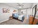 Spacious bedroom with a full bed, mid-century modern dresser, and artwork on the walls at 2264 E Holmes Ave, Mesa, AZ 85204