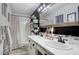 Modern bathroom featuring dual vanities, white cabinets, and a tiled shower at 2306 W Corrine Dr, Phoenix, AZ 85029