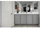 Double vanity bathroom with gray cabinets and a large mirror at 23793 W Ripple Rd, Buckeye, AZ 85326