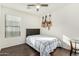 Cozy bedroom with wood floors, window blinds, and guitar decor at 2515 S 100Th Dr, Tolleson, AZ 85353