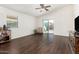 Living room with sliding door to backyard and dark hardwood floors at 2515 S 100Th Dr, Tolleson, AZ 85353