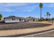 Charming single-story home with gray exterior, rock landscaping, and palm trees at 2621 E Virginia Ave, Phoenix, AZ 85008