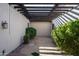 Lush green plants line this covered patio area, creating a serene outdoor space at 35150 N 53Rd Pl, Cave Creek, AZ 85331