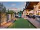 Covered patio with a putting green, outdoor seating, and a fire pit at 35150 N 53Rd Pl, Cave Creek, AZ 85331