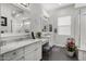 Elegant bathroom featuring double vanities, marble countertops, and a subway tile shower at 3837 E Crittenden Ln, Phoenix, AZ 85018