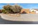 Inviting front yard with desert landscaping and a three-car garage at 4314 W Saguaro Park Ln, Glendale, AZ 85310