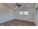 Bright bedroom with wood-look flooring, ceiling fan, and multiple windows at 4426 S 21St St, Phoenix, AZ 85040