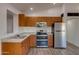 Modern kitchen featuring stainless steel appliances and wood cabinetry at 4426 S 21St St, Phoenix, AZ 85040