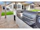 Outdoor kitchen with built-in grill and smoker in a backyard at 4711 N 212Th Dr, Buckeye, AZ 85396