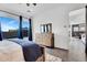 Bedroom with large windows, wooden dresser, and view of backyard and dining area at 4711 N 212Th Dr, Buckeye, AZ 85396