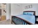 Guest bedroom with wooden bedframe and plush carpeting at 4711 N 212Th Dr, Buckeye, AZ 85396