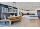 Dining area with large wooden table, bench seating, and adjacent, modern kitchen at 4711 N 212Th Dr, Buckeye, AZ 85396