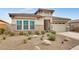Charming single-story home with stone accents, a well-manicured lawn, and desert landscaping at 4711 N 212Th Dr, Buckeye, AZ 85396