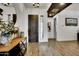 Entryway with wood-look tile, a dark wood door, and a console table at 4711 N 212Th Dr, Buckeye, AZ 85396