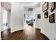 Welcoming hallway leading to the living area, featuring wood-look tile flooring and decorative wall art at 4711 N 212Th Dr, Buckeye, AZ 85396