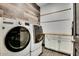 Spacious laundry room with white washer and dryer at 4711 N 212Th Dr, Buckeye, AZ 85396
