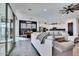 Spacious living room with sliding glass doors, view to the dining area, and modern kitchen at 4711 N 212Th Dr, Buckeye, AZ 85396