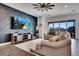 Living room featuring a large TV, comfortable seating, and sliding glass doors at 4711 N 212Th Dr, Buckeye, AZ 85396