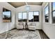 Cozy sunroom with large windows, vaulted ceiling, and two armchairs at 4711 N 212Th Dr, Buckeye, AZ 85396