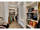 Spacious walk-in closet with shelves, hanging rods, and a sitting area at 4711 N 212Th Dr, Buckeye, AZ 85396
