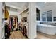 Walk-in closet with ample storage space, including shelves, hanging rods, and a window at 4711 N 212Th Dr, Buckeye, AZ 85396