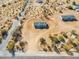 An aerial view showcasing the home's location and the surrounding desert landscape at 51937 W Wildwood Rd, Maricopa, AZ 85139