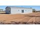 Backyard view of the house with a patio and open land at 51937 W Wildwood Rd, Maricopa, AZ 85139
